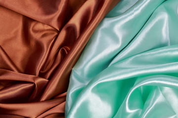 Brown and light green silk satin cloth of wavy folds texture bac