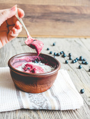 eating a banana ice cream with blueberries and coconut spoon, ha