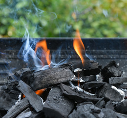 Burning charcoal on barbecue grill.