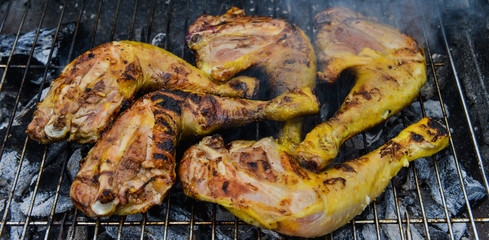 Chicken cooking on Barbecue grill, close-up