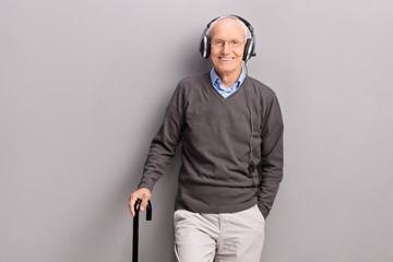 Senior man listening music on headphones