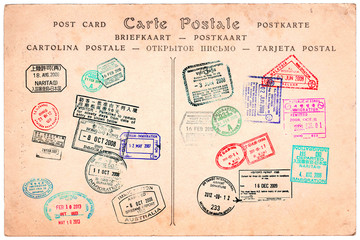 Collection of passport stamps on a vintage postcard background