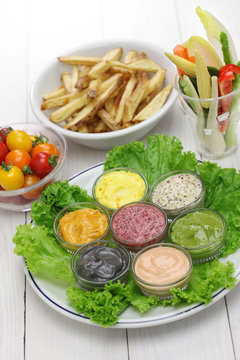 assorted mayonnaise sauce with french fries and raw vegetables
