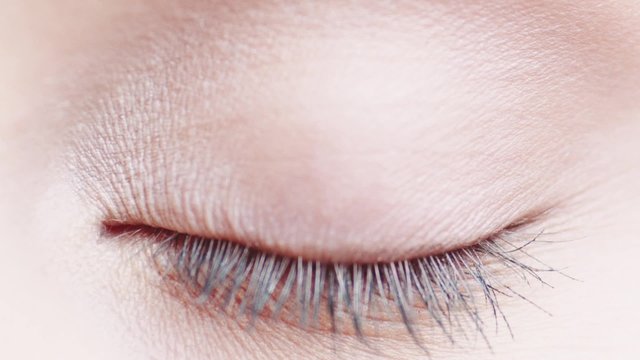 Macro Close-up Eye Blinking. Slow Motion, 120 Fps. Young Woman Is Opening And Closing Her Beautiful Eye.