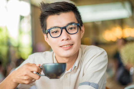 Man drinking coffee and holding cup