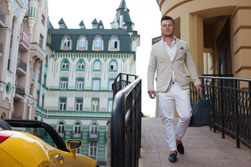 Stylish man walking after luxury shopping