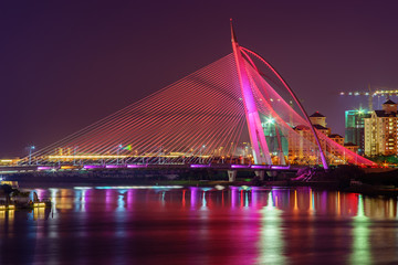 Fototapeta na wymiar Beautiful modern bridge with reflection at night in red colour