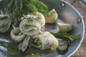 Pickled rollmops herrings with dill