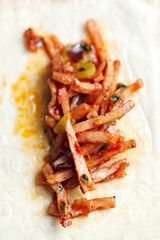 Fried meat with corn on pita bread.