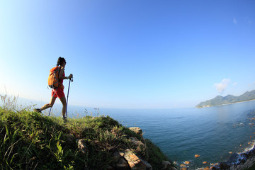  young woman hiking on seaside mountain trail