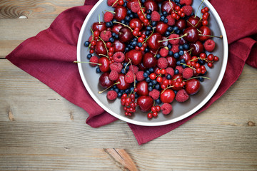  Fresh wild berries: raspberries, blueberries, currants and cherries. Top view 
