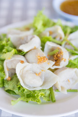 Steamed dumplings on white plate