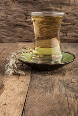 sage tea and sage leafs on wooden table