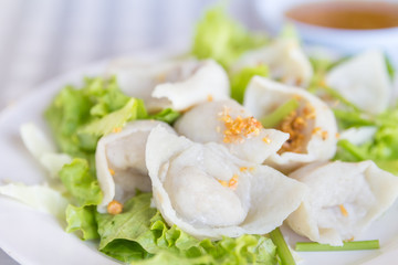 Steamed dumplings on white plate