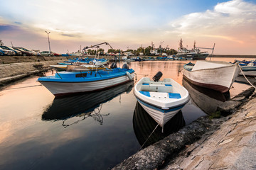 Fototapeta premium fishing boats in port of Sozopol at sunrise