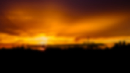 abstract blurred background of sunrise over factory