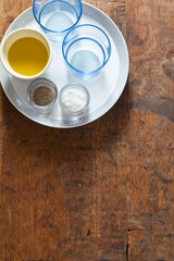 Obraz na płótnie Canvas Serving dinner table. two empty blue glasses, olive oil, salt an