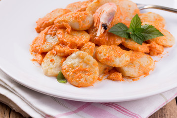 gnocchi with tomato sauce and basil on a tablecloth 
