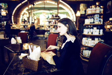young elegant brunette woman in cafe drinking coffee