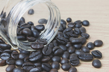 coffee and glass jar on a wooden background.