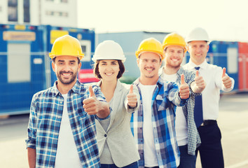 group of smiling builders in hardhats outdoors