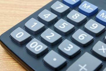 calculator number one button on a wooden.