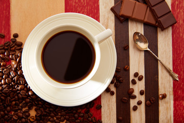 Coffee cup with chocolate and coffee beans