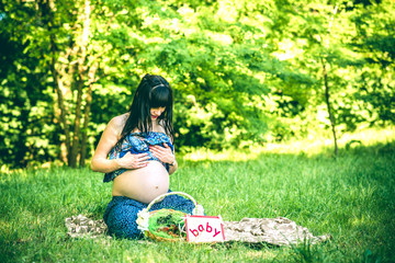 Pregnant woman relaxing outdoor in the park