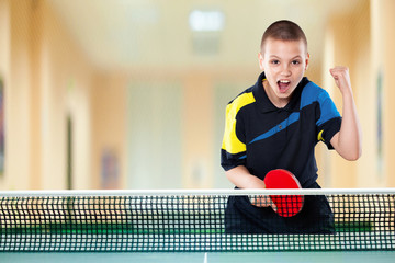 Little boy celebrating flawless victory in table tennis