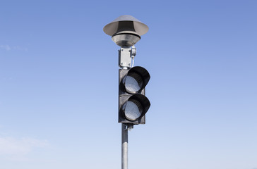 An isolated pole with a stop light