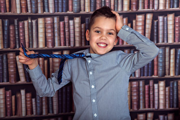 Smiling boy pulling his tie