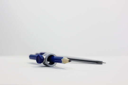 metal compass with blue pencil 
