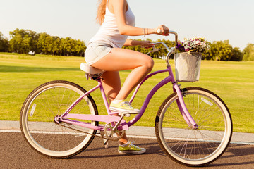 girl riding on a bicycle with flowers