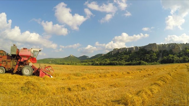 Combine Harvester Collecting Grains At Picturesque Place