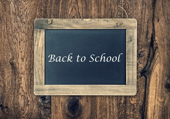 Vintage blackboard on wooden wall. Back to School