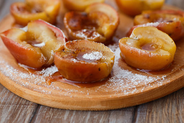 Baked apples on wooden board, selective focus