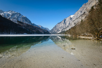 Winter landscape with frozen lake and mountains in background.Leopoldsteiner see,Styria,Austria.