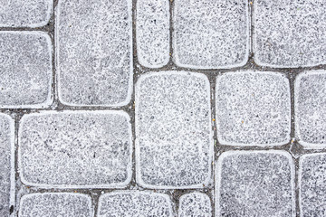 Grunge white paint pavement blocks.