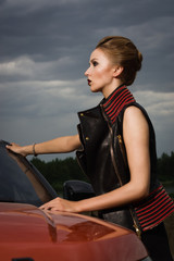 Fototapeta na wymiar Fashion woman standing near vehicle