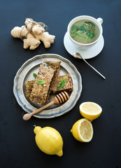 Cup of herbal tea with fresh mint, honey, lemon, ginger on