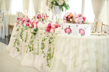 Arrangement of pink and white flowers in restaurant for luxury wedding event