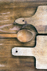 wooden cutting boards and spoon on a wooden background 