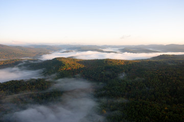 An aerial view of a hot air balloon floating over the Vermont country side ..