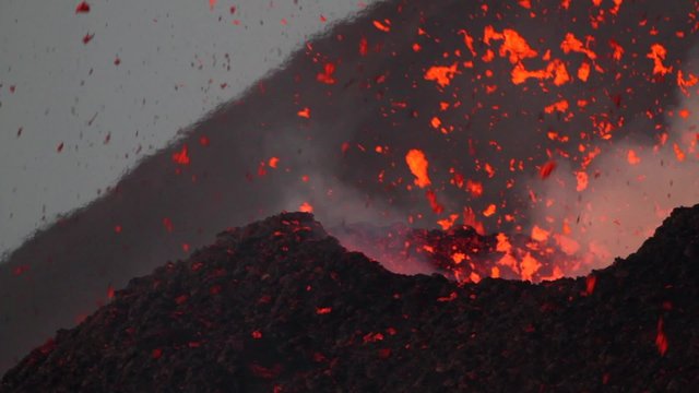 Lava spattering at dawn. Mount Etna eruption