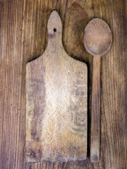 wooden cutting board and spoon on a wooden background 
