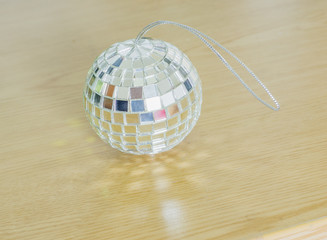 Glass balls with shiny light wood on the ground.
