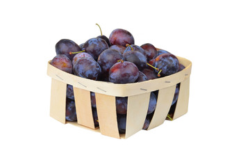 Plum in a wattled basket, isolated on a white background