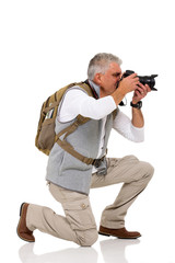 male tourist on his knee taking pictures