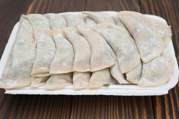 homemade dumpling filled with vegetable  on wooden board