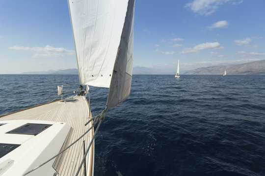 Yachting. Sailing in the wind through the waves. Luxury yachts.